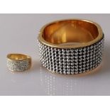 A Swarovski gold-coloured cuff hinged bangle and similar ring (2)