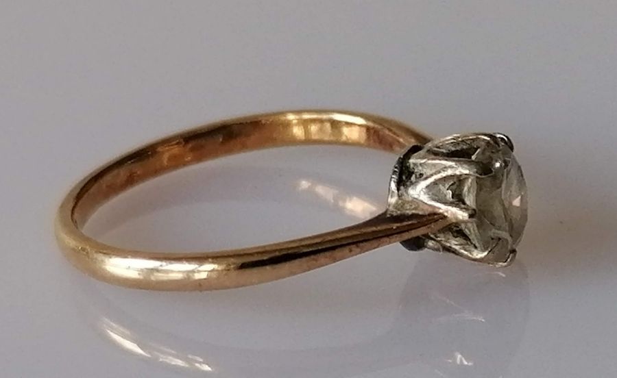 A solitaire diamond ring in a claw-set gold setting, the round-cut diamond approximately 0.75 carats - Image 3 of 4