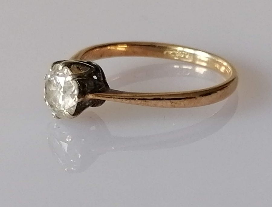 A solitaire diamond ring in a claw-set gold setting, the round-cut diamond approximately 0.75 carats - Image 2 of 4