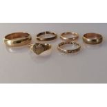 Four 9ct yellow gold wedding bands, one cut, sizes X, P, l1/2, K, a heart-shape ring,