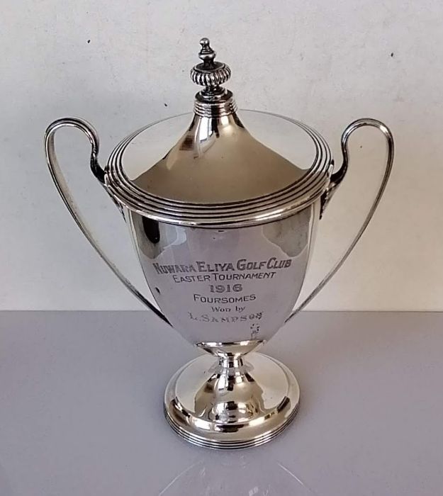 A George V silver two-handled trophy cup and cover the the neo-classical style on a turned ebonised - Image 2 of 2