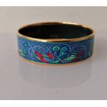 A Hermes gold tone and enamel bangle, internal diameter 60mm, with logo and Made In Austria