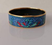A Hermes gold tone and enamel bangle, internal diameter 60mm, with logo and Made In Austria