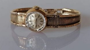 A mid-century ladies Omega gold dress watch with silvered dial, baton markers, dial 12mm
