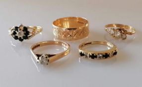 A selection of four gem-set 9ct yellow gold rings and an etched wedding band, all hallmarked