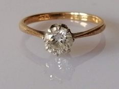 A solitaire diamond ring in a claw-set gold setting, the round-cut diamond approximately 0.75 carats