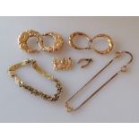 An assortment of 9ct gold jewellery to include two pairs of earrings, two bracelets and two charms