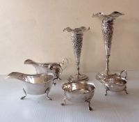 Two Indian-style silver trumpet-shape vases with embossed decoration, wavy rims, 18, 22 cm