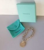 A Tiffany silver bracelet with 'Return to Tiffany' medal charm and original pouch/box