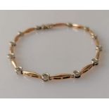 A rose and white gold diamond set line bracelet