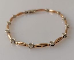 A rose and white gold diamond set line bracelet