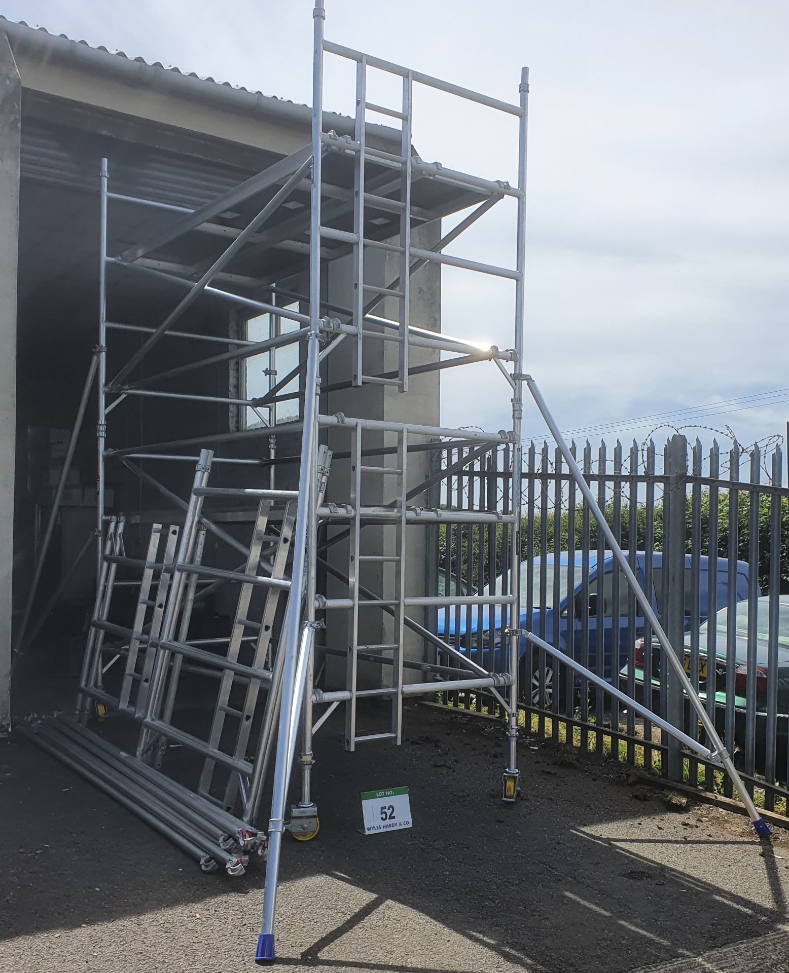 A LEWIS Eight 7.6M Section Light Alloy Scaffold Tower with fitted Ladder, Four Castor Wheels, Four