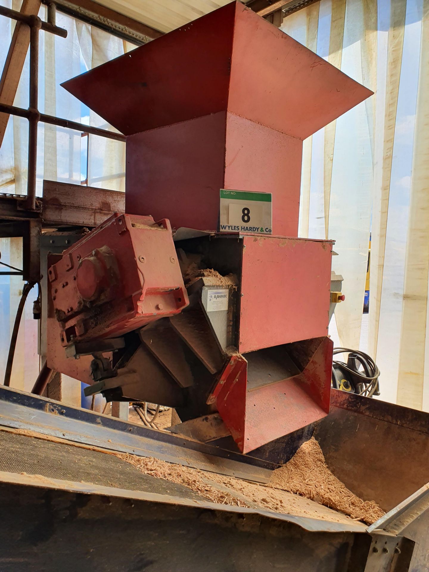 An IRS 850-700 Waste Wood Shredder on Steel Frame with approx. 4M Inclined Belt Take-Off Conveyor (