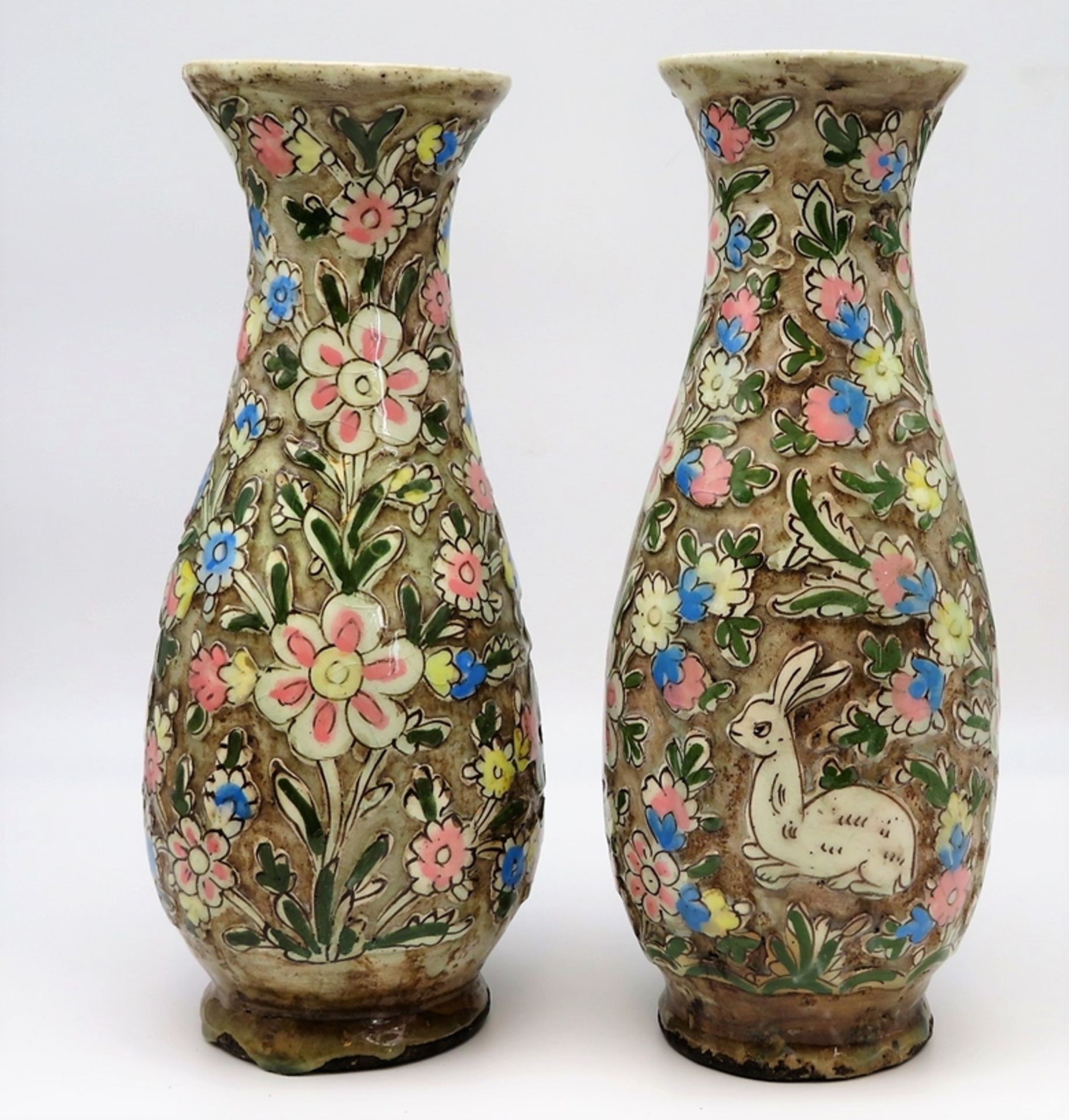 2 Vasen, Persien, antik, Fayence mit Reliefdekor von Blüten und Hasen, polychrom glasiert, 1 x am H