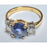 18ct yellow gold ring set with a central round cut Sapphire (approx 2.2cts) flanked to either side