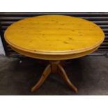 Round Pine extending dining table on pedestal base