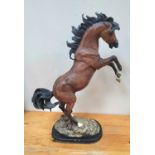 Large unmarked porcelain rearing horse on wood plinth