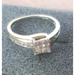18K gold ring with central area of diamonds set in a square formation together with round cut