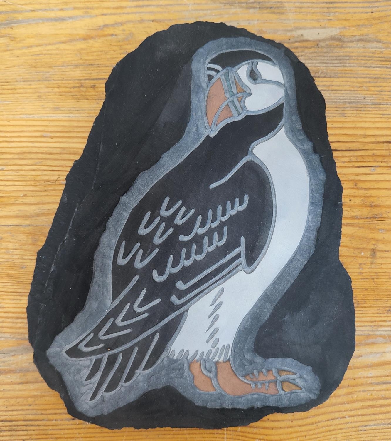 Engraved and coloured bird on slate