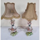 Pair of mid 20thC hand painted ornate porcelain figurine lamps (2)