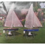 Pair of large racing yachts with stands (2)