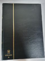 Black stock book containing Turks and Caicos mint stamps and sets QV to QEII together with South