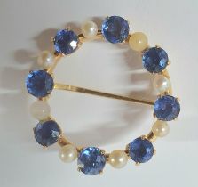 Unmarked circular gold brooch with round cut Sapphires interspersed with seed Pearls, 3.9 grams