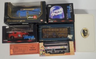 collection of die cast models including the "green goddess" and a golden Japanese bus