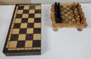 two wooden chess boards with pieces