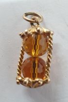 9ct yellow gold charm/pendant in the form of an hour-glass, 3 grams gross