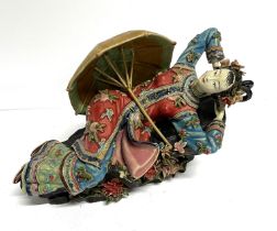Finely made Oriental ceramic figurine, depicting a reclining lady with a parasol, extensively