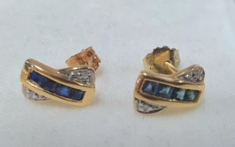 Pair of ladies 750 yellow gold earring containing 4 square cut Sapphires with a small illusion set