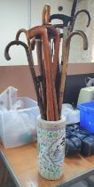 Decorated Chinese ceramic stick stand crammed full of umbrellas and walking sticks including antique