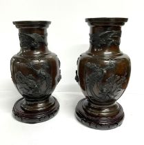 Stunning ornate pair of large antique Japanese bronze vases on wood plinths, both stamped to base (