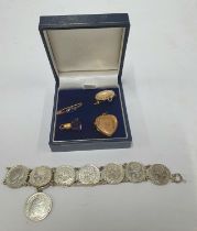 Four pieces of antique non-gold jewellery including a rolled gold heart locket and a 3d silver