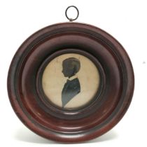 Antique circular mahogany framed pen and ink silhouette of a boy 17cm diameter