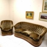 Curved button back sofa and armchair upholstered in brown, with feather loose seat cushions. chair