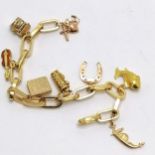 18ct gold charm bracelet with 8 charms i) 9ct faith/hope/charity ii) 9ct Chim opening well iii) 18ct