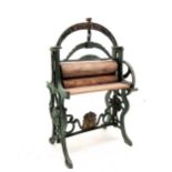 Antique dolls mangle 'The Lion Mangle' in green painted cast iron and oak rollers 26cm high x 18cm