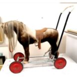 a Vintage plush push a long horse on wheels, play worn condition 62 cms to top of head.