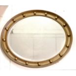 Oval gilt framed bevelled mirror 60cm x 50cm. in good used condition