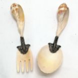 Pair of antique unmarked silver mounted shell salad servers 22cm long. Some wear to the mounts
