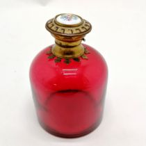 Antique cranberry glass scent bottle with gilt metal hinged lid with porcelain floral plaque to