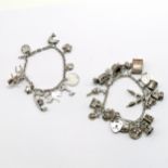 2 x silver charm bracelets with charms inc 10/- note, 2 x elephants, hats etc - total weight 61g