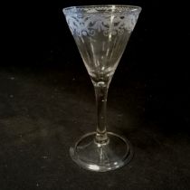 Mid 18th century wine glass with folded footrim and unusual classical etched border to top and