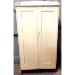 Pale yellow painted 2 door pine cupboard. 67 cms in width, 27 cms in depth, 133 in height.