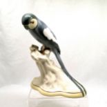Lasolware figure of a parrot perched on a branch, 31 cms high. Some paint loses to tail and rubbing.
