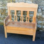 Continental pine hall settle with storage compartment to the seat. 110cm x 102cm x 42cm. In