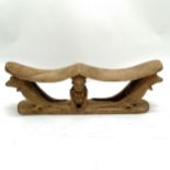 Carved wooden tribal double headrest with 2 kneeling figures and 4 crocodiles. 38cm x 13cm. Some