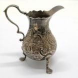 George II baluster cream jug with embossed bird decoration and crest to the cartouche by Samual